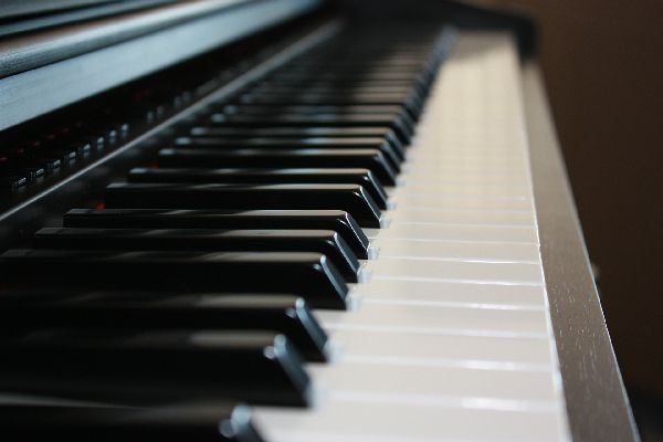 just4uentertainment image of a beautiful grand piano ebony and ivory keyboard at a Salt Lake City wedding reception